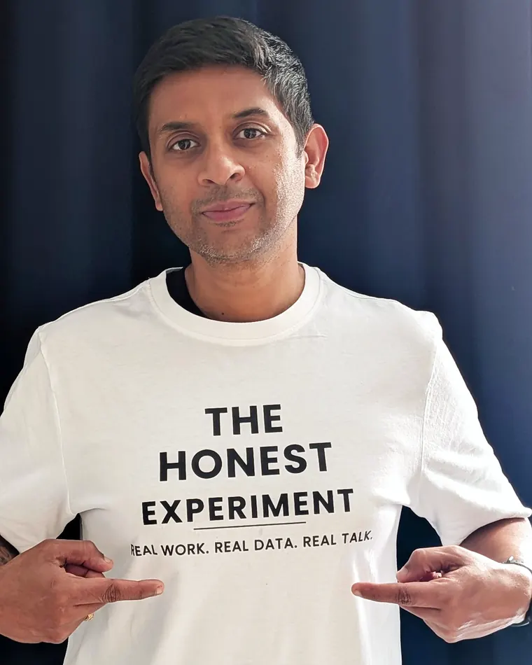 Priyanku Nandi wearing a The Honest Experiment t-shirt with the tagline Real work. Real data. Real talk.